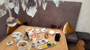 a wooden table with a plate of food on it at Timeless Dolomites Apartments in Dobbiaco