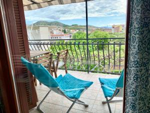 a patio with two chairs and a balcony with a view at Apartments Beata in Marina
