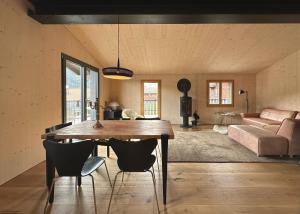 a living room with a table and chairs and a couch at Casa Glisch im Zentrum von Sedrun, mit Sauna in Sedrun