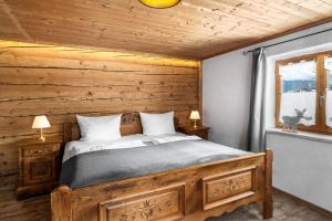 a bedroom with a bed in a wooden cabin at Landhaus Speiser in Bolsterlang