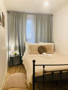 a bedroom with a large bed with a window at Apartament lovely space in Rzeszów