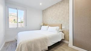 A bed or beds in a room at Vistas al mar - Primera línea playa de Malagueta