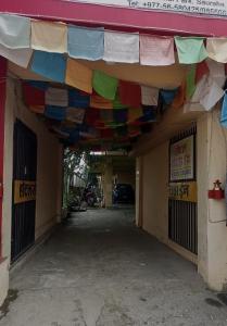 a building with a bunch of flags hanging over it at Sauraha Inn in Sauraha