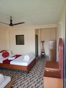 a hotel room with a bed and a camera at Sauraha Inn in Sauraha