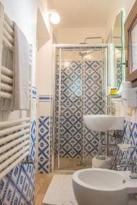 a blue and white bathroom with a sink and a shower at Dimora Dell'Osanna in Carovigno