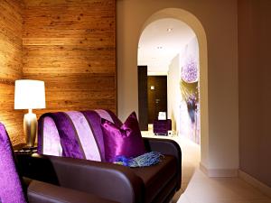 a living room with purple pillows on a couch at Apart Montanara in Ischgl