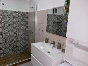 a white bathroom with a sink and a shower at El-Mi's little house in Theologos in Theologos