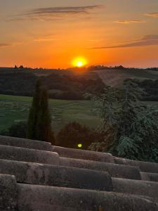 a sunset seen from the top of a stone wall at Podere Cedrola in Asciano