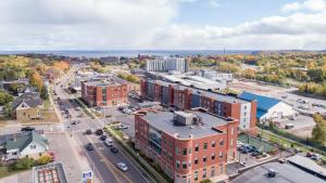 an aerial view of a city with buildings and a street at Staybridge Suites Marquette by IHG in Marquette