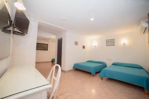 Postel nebo postele na pokoji v ubytování Hotel Rivemar