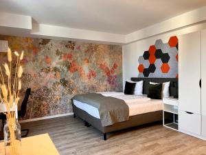 a bedroom with a bed and a colorful wall at SOFI-LIVING-APARTMENTS in Hannover