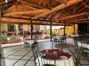 a patio with tables and chairs in a restaurant at Arusha Centre Rooms in Arusha