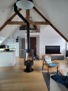 a living room with a fireplace in a loft at Les Sternes - centre ville- garage in Concarneau