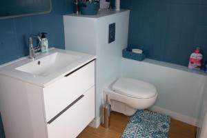 a bathroom with a white sink and a toilet at Les Sternes - centre ville- garage in Concarneau +12 photos