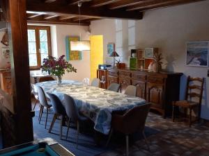 a dining room with a table and chairs and a kitchen at Gîte de Charme avec Spa, Billard, Jardin et Ping-Pong - FR-1-586-54 in Vinon