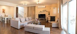 a living room with a couch and a table at Villa Eva στην περιοχή Ερέτρια in Eretria +142 photos