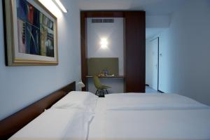 Letto o letti in una camera di Hotel Ceresio