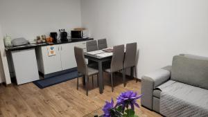 a kitchen with a table and chairs and a couch at The Blue Hydrangea in Vila Franca do Campo +4 photos