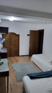 a bedroom with two beds and wooden cabinets at The Blue Hydrangea in Vila Franca do Campo