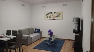 a living room with a couch and a table at The Blue Hydrangea in Vila Franca do Campo