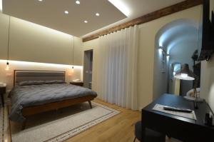 Ένα ή περισσότερα κρεβάτια σε δωμάτιο στο Il Palazzotto