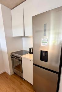 a kitchen with a refrigerator and a stove at Brand New! Urban Bliss Stay - Luxe Living in Montevideo +14 photos