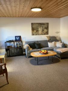 a living room with a couch and a table at Ferienwohnung Barbara in Kirchhundem