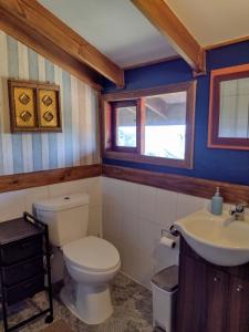 a bathroom with a toilet and a sink at Casa costa Panitao, Puerto Montt in Puerto Montt