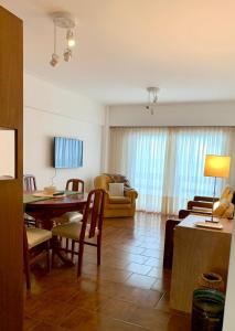a living room with a table and a dining room at Departamento Frente al Mar, Edif Iskofema II in Miramar
