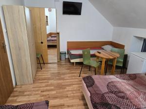 a room with a table and a bed and a table and chairs at KWT Hostel Nowogard - Self Check-In - Wejscie na KOD in Nowogard