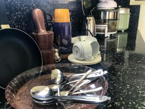 a kitchen counter with spoons and utensils on a table at Oneida Villa & Restaurant in Talpe