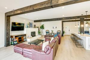 a living room with leather couches and a fireplace at Fish, Boat and Unwind Old Hickory Lake Retreat in Nonaville