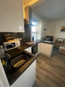 a kitchen with a sink and a counter top at Stonehaven Centre - Dunnottar Apartment in Stonehaven +13 photos