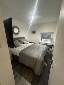 a bedroom with a bed and a desk and a window at Stonehaven Centre - Dunnottar Apartment in Stonehaven