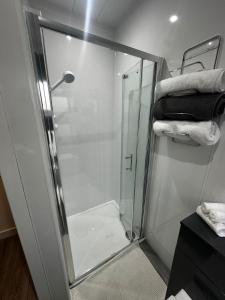 a shower with a glass door in a bathroom at Stonehaven Centre - Dunnottar Apartment in Stonehaven