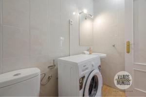 a white bathroom with a washing machine and a sink at Despertar en Madrid para 2, Carretas 25 in Madrid