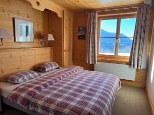 a bedroom with a bed and a window at Luxury chalet in Les Diablerets Villars ski area in Les Diablerets +13 photos
