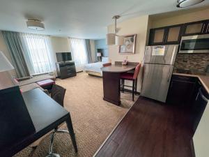 a large room with a kitchen and a bedroom at Staybridge Suites Marquette by IHG in Marquette