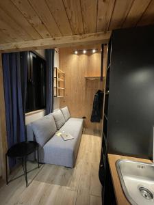 a small living room with a couch and a sink at Montana in Kopaonik