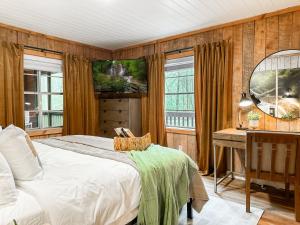 a bedroom with a bed and a desk and windows at 200ft Fightingtown Creek Frnthot Tubarcd in Blue Ridge