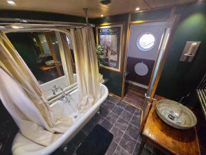 a large bathroom with a tub and a sink at Selene Unique Luxury Houseboat Experience in Chertsey +33 photos