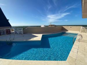 a swimming pool on the roof of a building at Tigre Center Tower F - seguridad 24hs - cochera incluida in Tigre