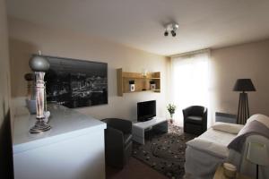 a living room with a couch and a table in a room at Sphinx Résidences - Tempologis Mémorial in Caen