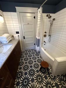 a bathroom with a black and white tile floor at The Farmhouse at Fort Hill in Peekskill