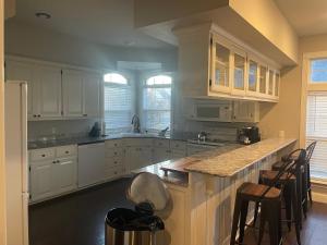 a kitchen with white cabinets and a counter top at Bentonville Biking and Business in Bentonville