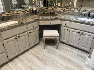 a kitchen with white cabinets and a stool in it at Bentonville Biking and Business in Bentonville +49 photos