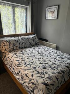 a bed in a bedroom with a comforter on it at Snipeview in Hagwothingham +12 photos