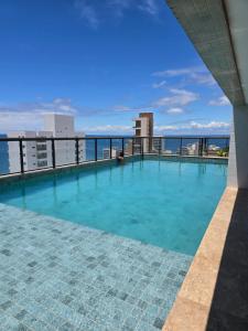 a swimming pool on the roof of a building at Perto do mar Self check in Infraestrutura completa in Salvador