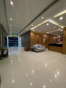 a lobby with a couch in the middle of a building at سكناي بارك للشقق المخدومة in Arar