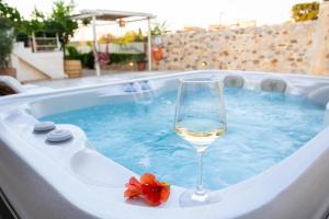 a glass of wine sitting in a hot tub at Villa Arancia in Pigi